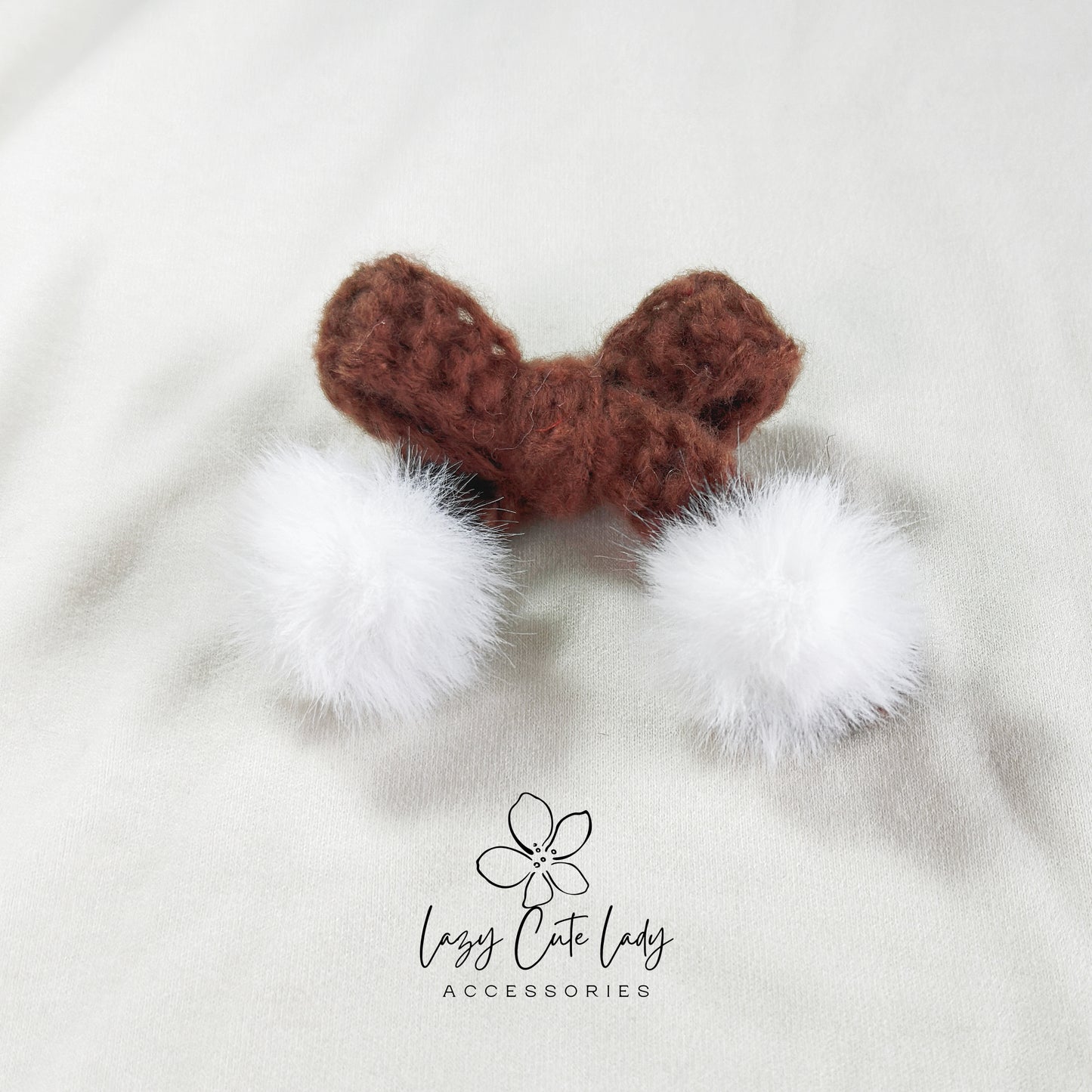 Knitted Bow Hair Clip with Plush White Ball Accent
