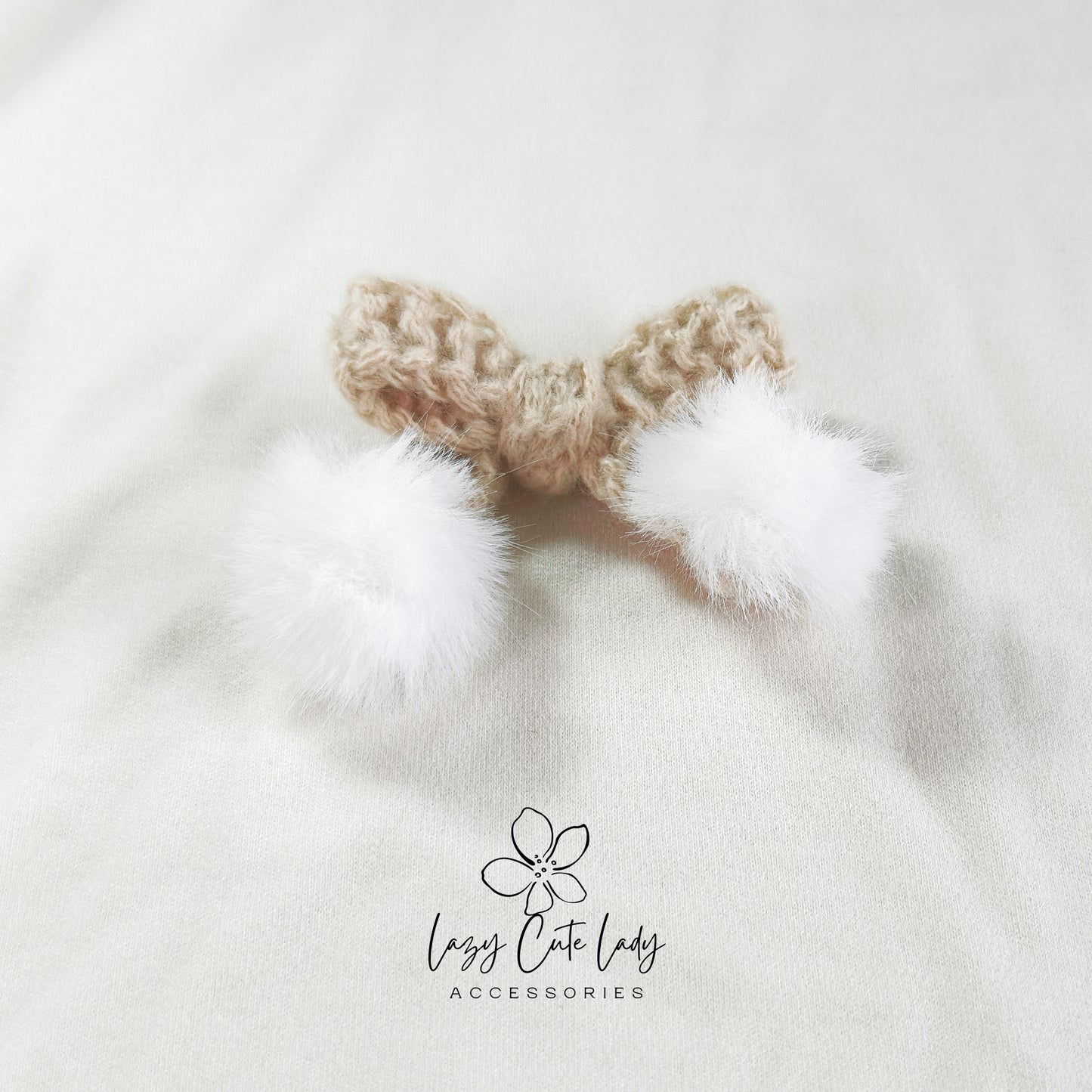 Knitted Bow Hair Clip with Plush White Ball Accent